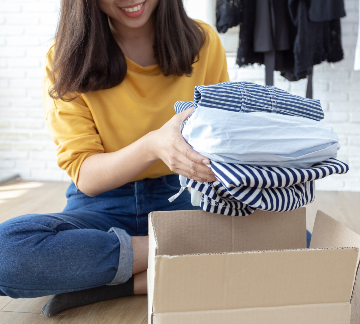 Woman putting clothes in boxes