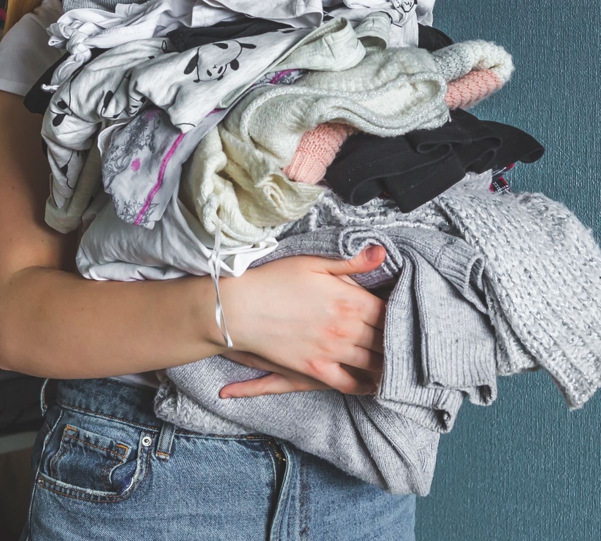 Teenager holding clothes to be donated