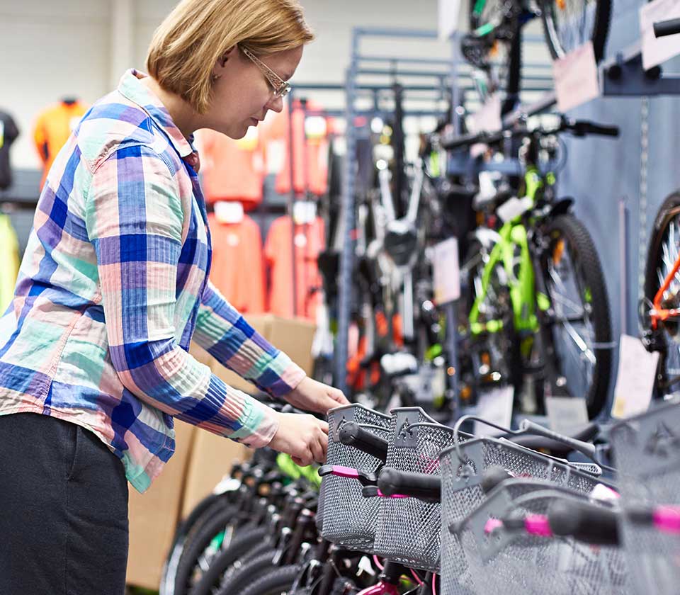 Woman looking at bikes in sports store