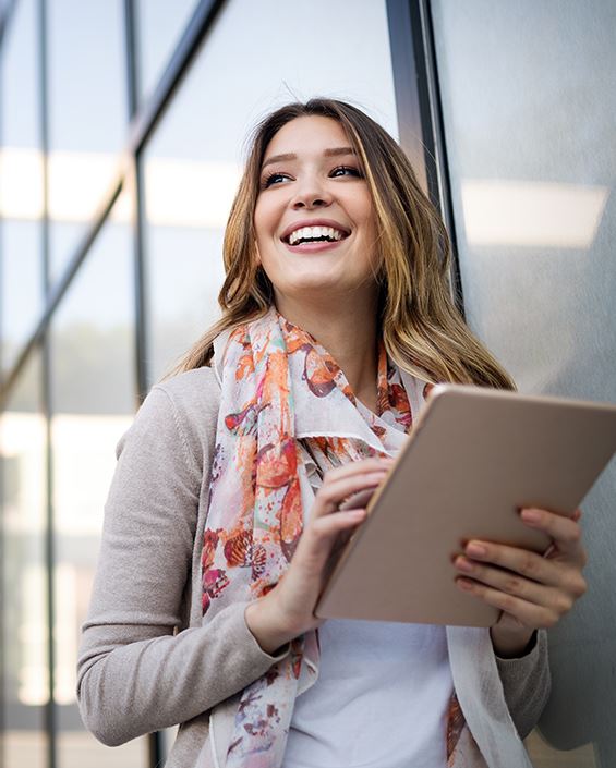 woman smiling holding ipad